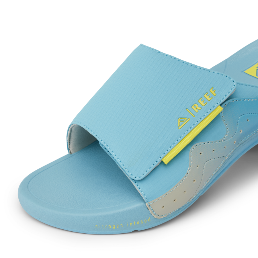 CJ7256_SWELL_CRUISER_SLIDE_LIGHT_BLUE_YELLOW_DTL1-900x900-c4cc11b.png